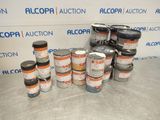 many cans of paint sitting on a table