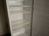 a white refrigerator with its door open in a room