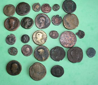 some of the old coins are on a green surface