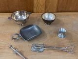 a wooden table with a variety of kitchen utensils on it