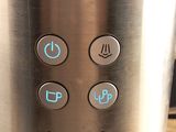 a close up of a coffee maker on a table