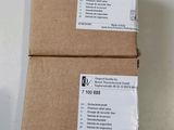 two boxes of brown paper sitting on top of a white table
