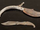 pair of antique silver plated knifes on a black surface