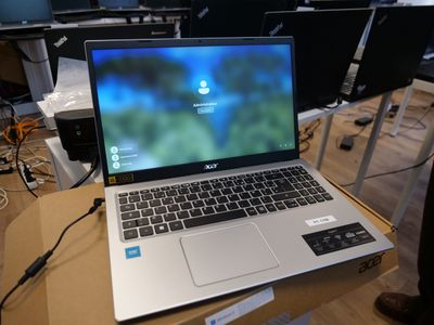a laptop computer sitting on top of a box on a table