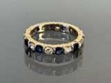 an image of a diamond and sapphire ring on a table