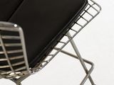 a black chair with a metal frame and a black seat