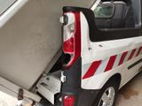 a white van with a red stripe parked in a garage