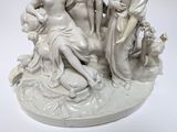 a statue of a group of women sitting on a rock