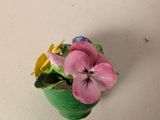 a small pot with flowers on a table