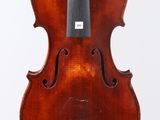 an old violin with a bow hanging from it ' s back