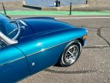 a blue sports car parked on the side of the road