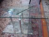 a glass table with a glass top on a rug