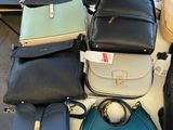 a lot of purses that are sitting on a table