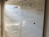 a white board on the wall in the room