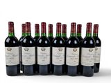six bottles of red wine lined up in a row on a white surface