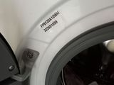 a close up of a washing machine with the door open