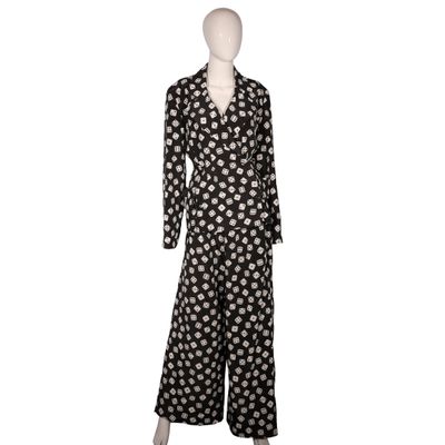 a black and white polka dot print long sleeved jumpsuit