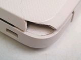 a close up of a cell phone with a hole in the back