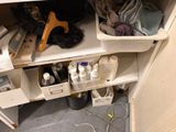 an image of a cluttered bathroom with a lot of clutter on the floor