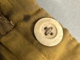 a button that is attached to a pair of pants