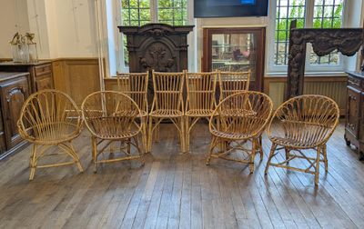 a room with a lot of chairs and a table in it