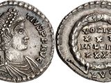 a silver coin with an image of a woman on it