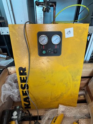a yellow machine that is sitting on a pallet