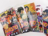 six naruto comic books lined up on a white surface