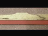 a picture of a piece of wood with a red edge