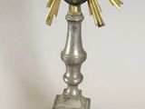 a silver and gold mirror with a sunburst on it