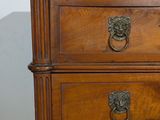 an image of a wooden chest of drawers with a lion head on it