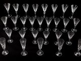 a lot of empty wine glasses on a black table