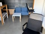 a black office chair and a blue couch in a room
