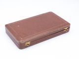 a small brown suitcase sitting on a white surface