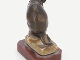 statue of a mouse on a marble base on a white background