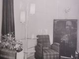 a black and white photo of a living room with a piano