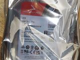 packaging of a hard drive on a table with a pair of scissors in it