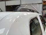 a white truck that is parked in a garage
