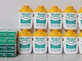 several bottles of biocanrex sit on a table next to a stack of boxes