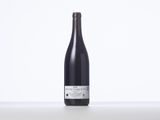 a bottle of wine sitting on top of a white table