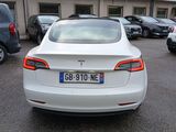a white tesla model s parked in a parking lot