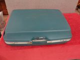 a blue suitcase sitting on a red table in a room
