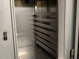 an open door to a commercial kitchen that is empty