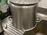 pots and pans are sitting on a sink in a kitchen
