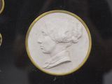 a picture of a coin with a woman ' s face on it