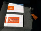 two business cards on the back of a car seat