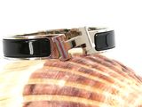 black and white bracelet with a silver clasp on a seashell