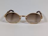 gold sunglasses with brown lenses on a white background