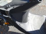 a close up of a motor scooter parked on the street