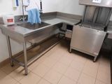 a stainless steel kitchen with a sink and a dishwasher